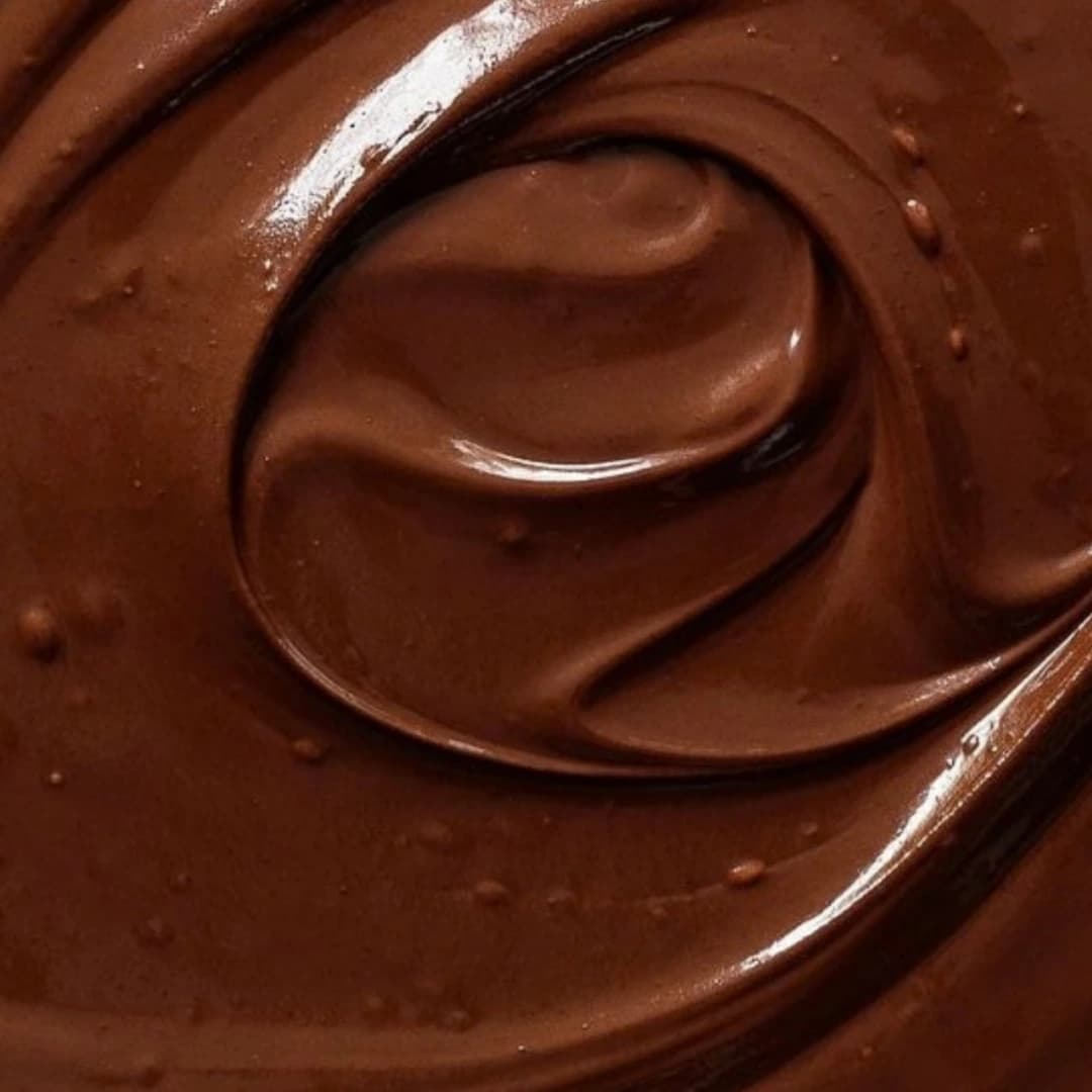 Broken milk chocolate bars on brown paper
